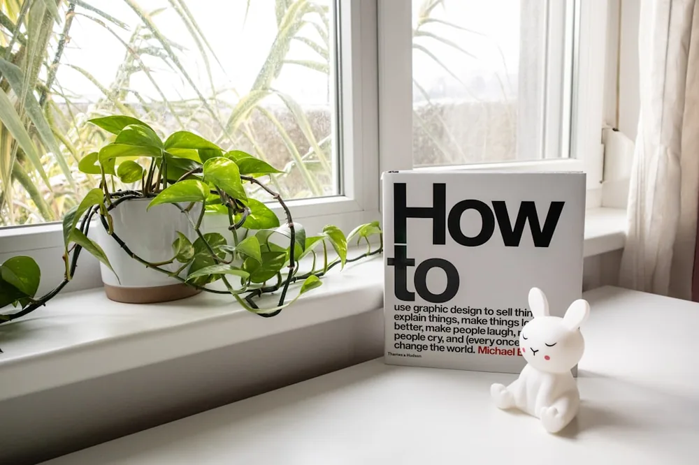 Dresser with a plant, a design book and the figure of a white rabbit